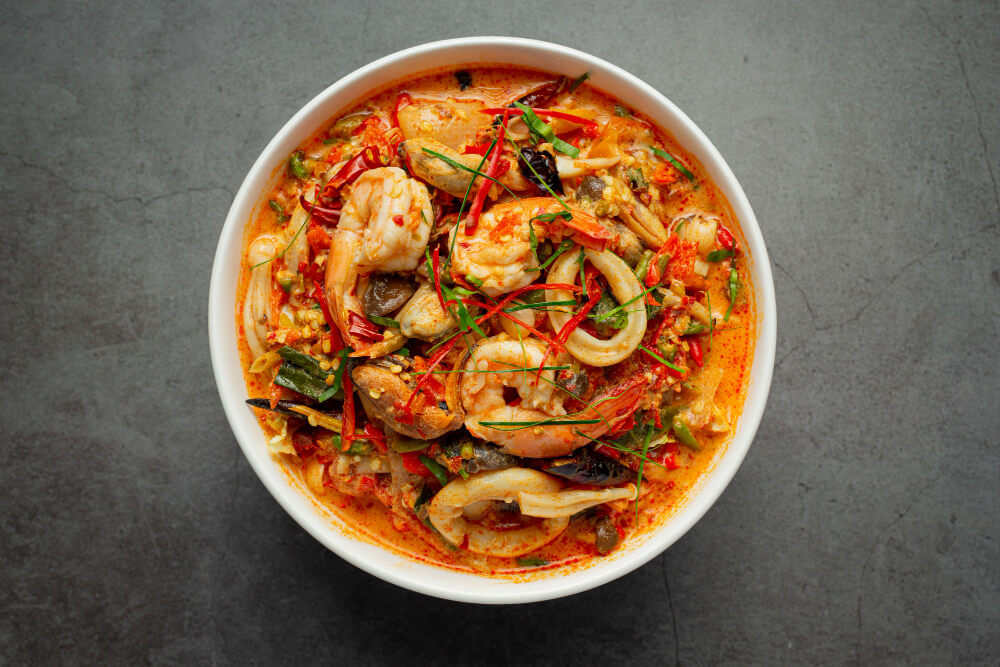 shrimp stew in a white ceramic bowl