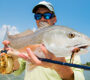 Fly fisherman holding a redfish