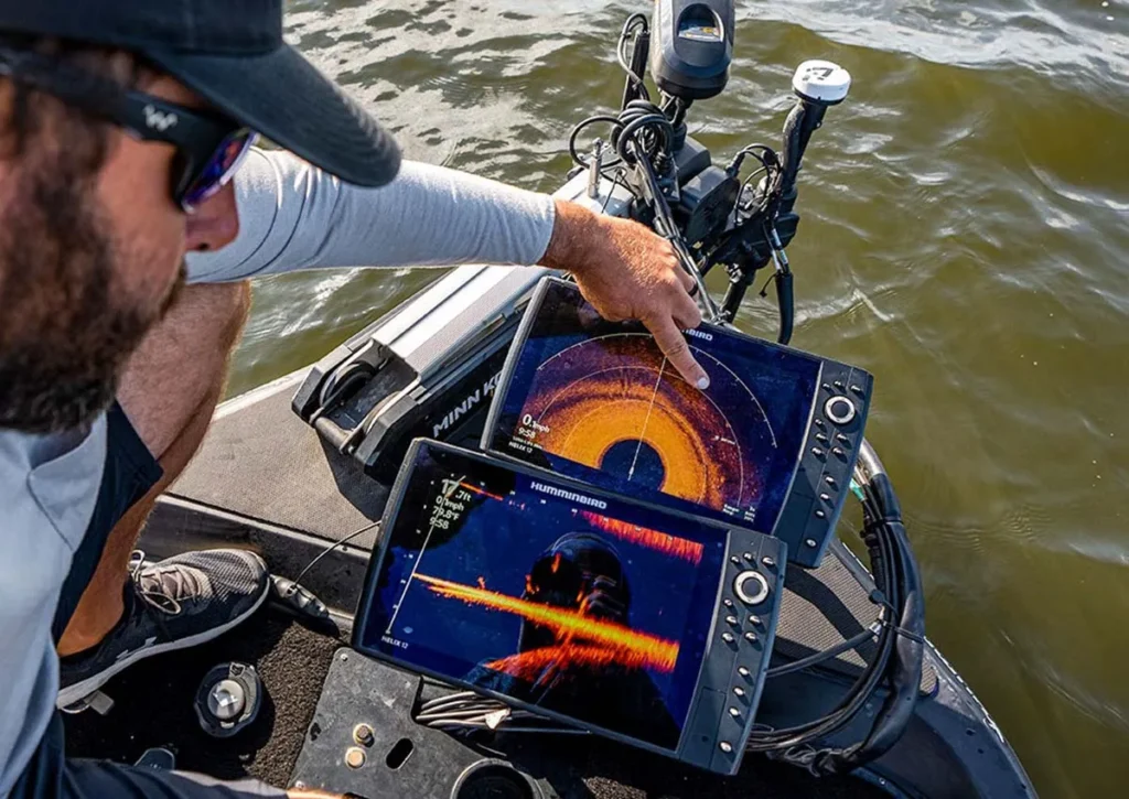 a man looking at the fish finder screen